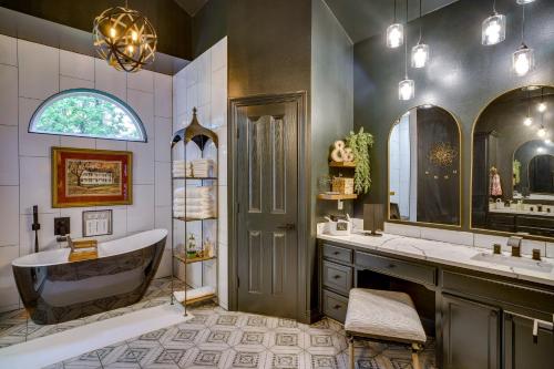 a bathroom with a tub and a sink at Elegant Baton Rouge Home with Yard about 3 Mi to LSU! in Baton Rouge