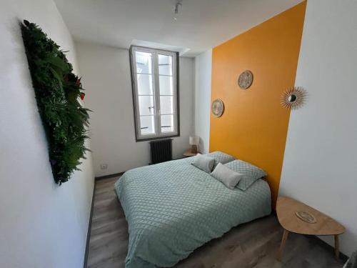 a bedroom with a bed and a window at Le petit jardin de Bellune in Niort