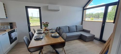 a kitchen and dining room with a table and chairs at Dwa Wymiary - Całoroczny domek z Jacuzzi i basenem podgrzewany w okresie wiosna - lato w cenie in Morawica