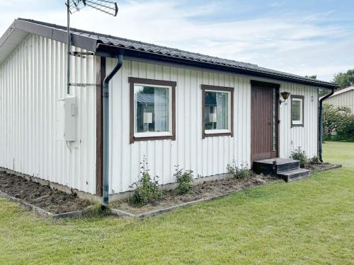 a small white house with a yard at Welcoming cottage near the sea-By Traum in Mellbystrand