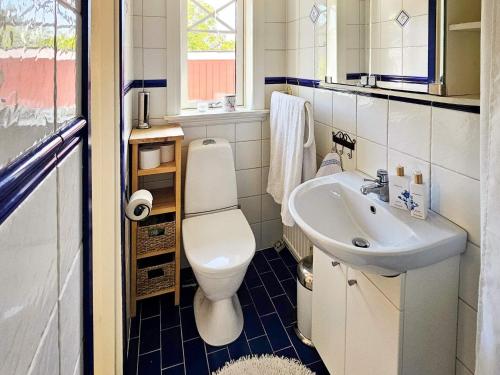 a bathroom with a toilet and a sink at 4 star holiday home in TJÖRN in Almösund