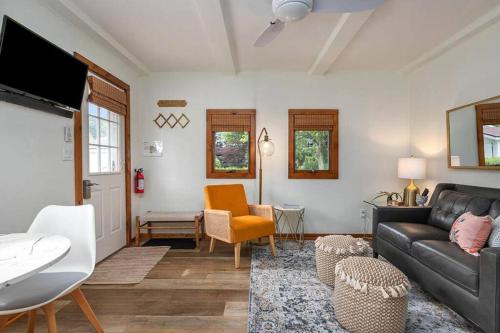 a living room with a couch and a table at 2min walk Downtown - Outdoor Patio - Pet Friendly in Saugatuck