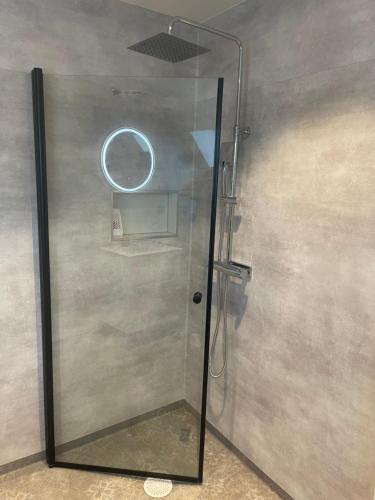 a shower with a glass door in a bathroom at Rådjursstigen 2A Vimmerby in Vimmerby