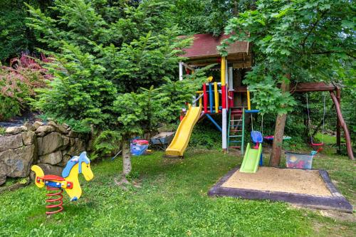 a playground with a slide in the grass at Tarninowe Wzgórze in Kunkowa