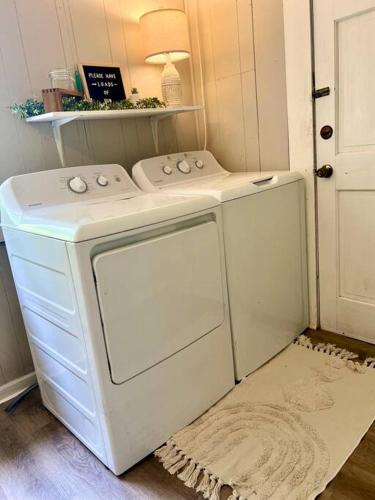 a washer and dryer sitting in a room at Quaint City Cottage Bremen, Ga in Bremen