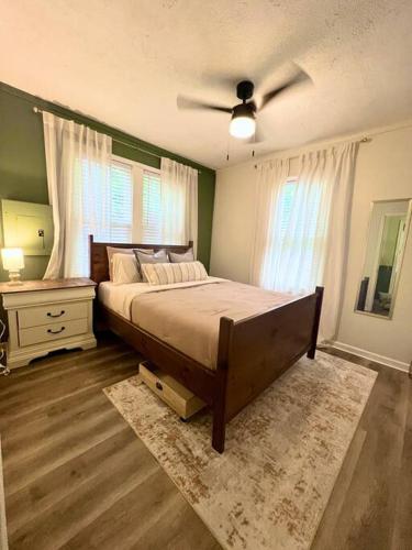 a bedroom with a bed and a ceiling fan at Quaint City Cottage Bremen, Ga in Bremen