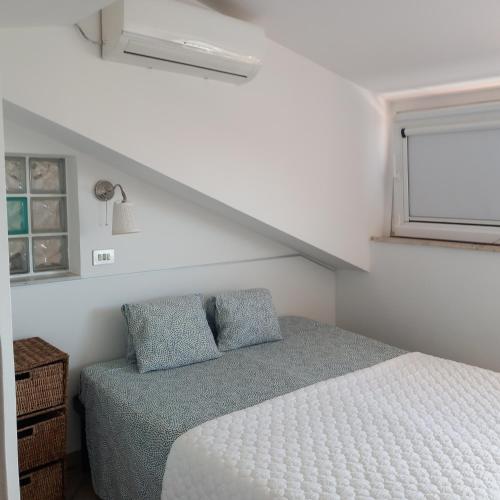 a small bedroom with a bed and a window at casa vacanza GIOIA in Civitanova Marche