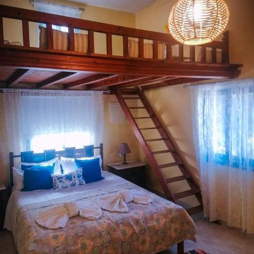 a bedroom with a large bed with two bunk beds at Zoes House in Kyra Panagia