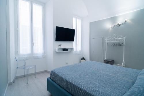 a bedroom with a bed and a tv on the wall at Carlo's FN66 - nel Cuore di Sanremo - in Sanremo