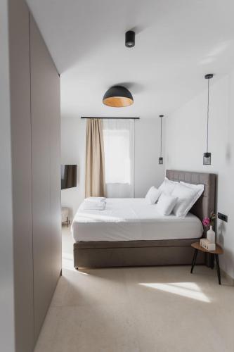 a white bedroom with a bed and a window at Luxury Villa Pam - Private villa with a heated pool and a summer terace with 4 bedrooms - 230 m2 NEW!! in Mandre