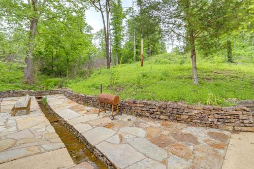 a stone wall and a bench in a park at Mountain-View Cabin on Farm 3 Mi to Town and Shops in Mountain View