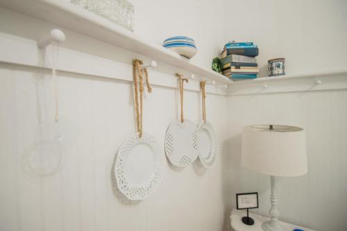 a kitchen with four stroons hanging on a wall at Mayson Room BW Boutique Hotel in Central Lake