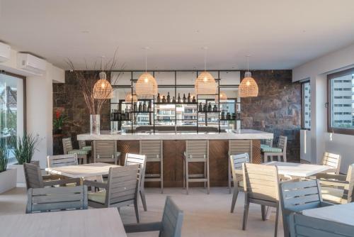 a restaurant with tables and chairs and a bar at Hotel Eloisa in Puerto Vallarta