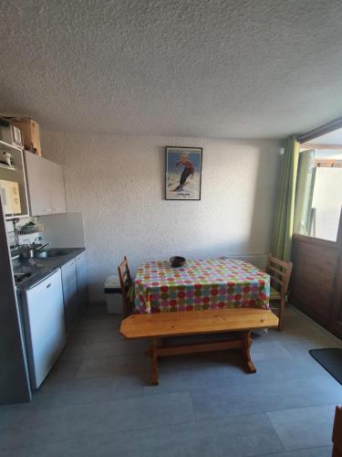 une pièce avec une table dans une cuisine avec dans l'établissement Appart Alpe d Huez, à L'Alpe-d'Huez