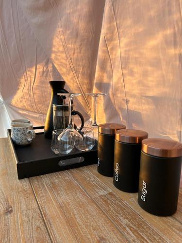 a tray with three coffee cups on a table at Forbord Dome in Tilleraune