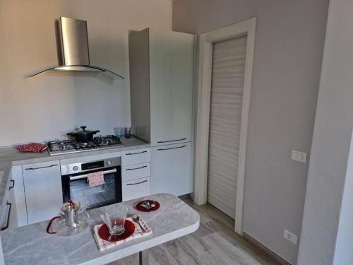 a kitchen with a stove and a table in it at La Casa del Borgo in Peccioli