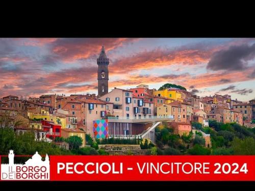 a painting of a city with a clock tower at La Casa del Borgo in Peccioli