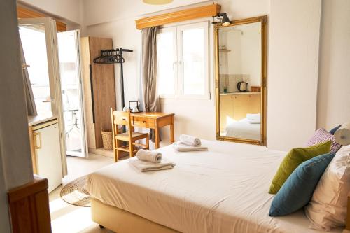 a bedroom with a large bed with towels on it at Malia Boutique Studios in Malia