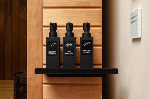 three bottles of hair products sitting on a shelf at Legato Spa Suites With Private Pool in Naxos Chora