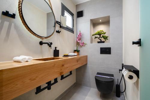 a bathroom with a sink and a mirror at Legato Spa Suites With Private Pool in Naxos Chora