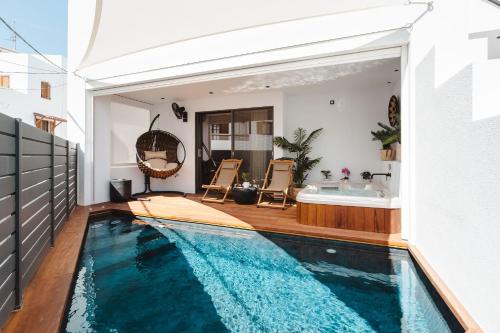 a house with a swimming pool and a bath tub at Legato Spa Suites With Private Pool in Naxos Chora
