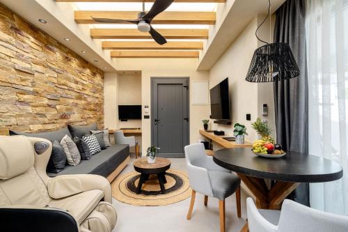 a living room with a couch and a table at Legato Spa Suites With Private Pool in Naxos Chora