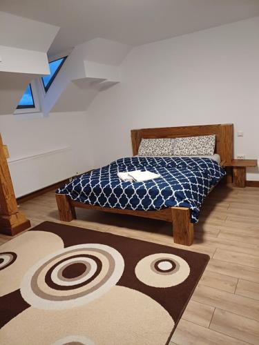 a bedroom with a bed and a rug on a floor at Cazare Rasnov in Râşnov
