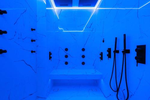 a bathroom with blue lighting and a wall at Legato Spa Suites With Private Pool in Naxos Chora