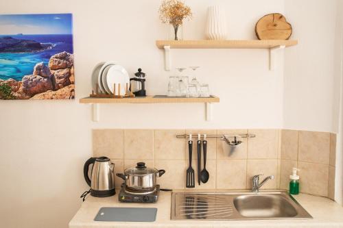 a kitchen counter with a sink and a stove at Malia Boutique Studios in Malia