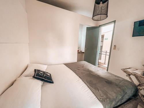 a bedroom with a bed with a pillow on it at Casa Tuxi in Rio de Janeiro