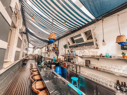a restaurant with a bar with tables and chairs at Casa Tuxi in Rio de Janeiro