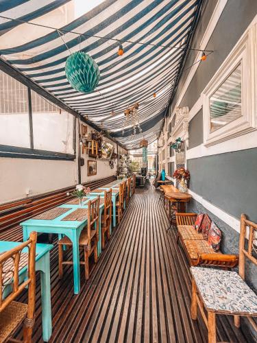 a restaurant with wooden tables and chairs and a ceiling at Casa Tuxi in Rio de Janeiro