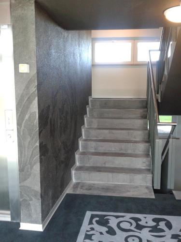 a staircase in a building with a stair case at Hotel Swiss Bellevue in Kreuzlingen