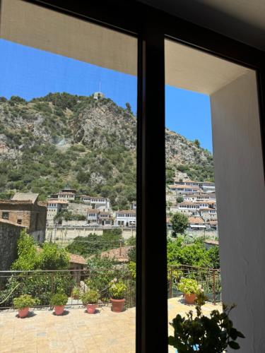 a view of a mountain from a window at MEROLI Guesthouse - UNESCO quarter in Berat