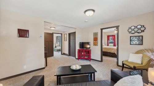 a living room with a couch and a tv at Red Hibiscus House - 3 Blocks from Lake Pepin in Lake City