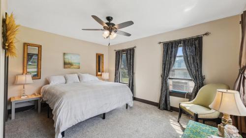 a bedroom with a bed and a ceiling fan at Red Hibiscus House - 3 Blocks from Lake Pepin in Lake City
