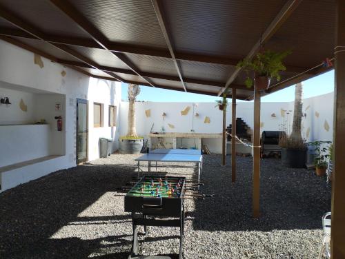 a patio with a ping pong table under a roof at Las palmeras B in Güimar