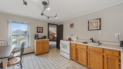 a kitchen with a sink and a counter top at Fire Lily Apartment - 3 Blocks from Lake Pepin in Lake City