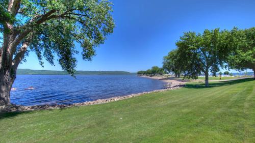 a view of a body of water with trees and grass at Jasmine Apartment - 3 Blocks from Lake Pepin in Lake City