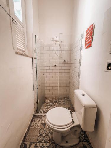 a bathroom with a toilet and a shower at Casa Tuxi in Rio de Janeiro
