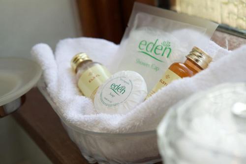 a basket with two bottles of soap and towels at Glede Knowe Guest House in Innerleithen