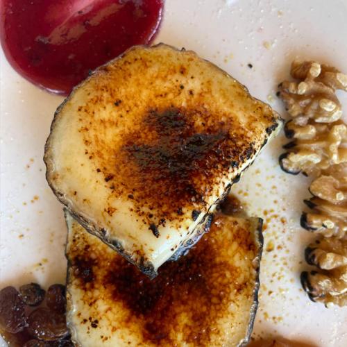 a white plate with a piece of food with nuts at Hotel Rural y Restaurante, Rinconcito de Gredos in Cuevas del Valle
