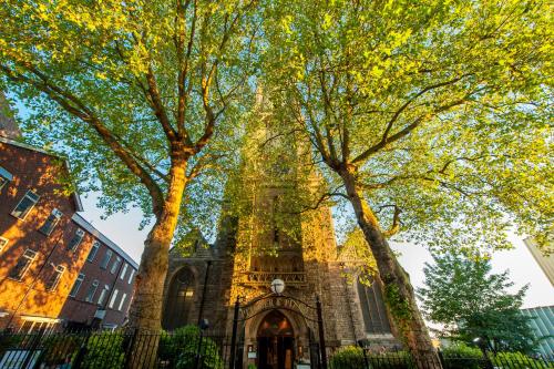 a church with two trees in front of it at Mercure Nottingham City Centre Hotel in Nottingham