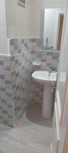 a bathroom with a sink and a mirror at Nador al jadid chaabi in Nador