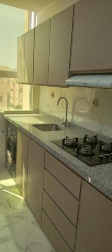 a kitchen with a sink and a counter top at Nador al jadid chaabi in Nador