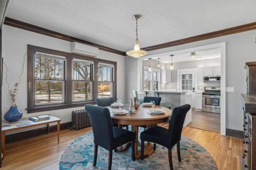 a dining room and living room with a table and chairs at Garden Apt, Majestic MPLS Duplex in Minneapolis