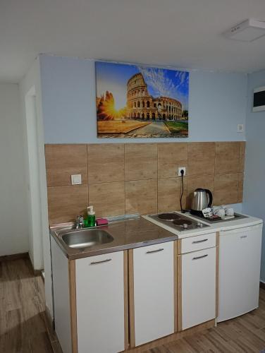 a kitchen with a sink and a counter top at Serenita Stone House in Becici
