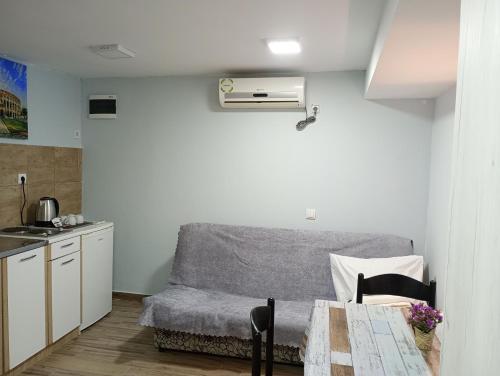 a kitchen with a couch and a table in a room at Serenita Stone House in Becici