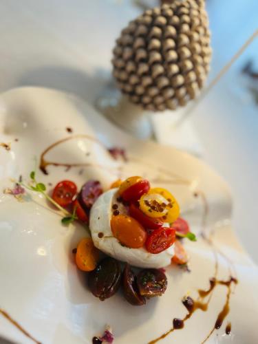a plate of food with eggs and vegetables on it at VIVERONE LAKE ROOMS in Viverone
