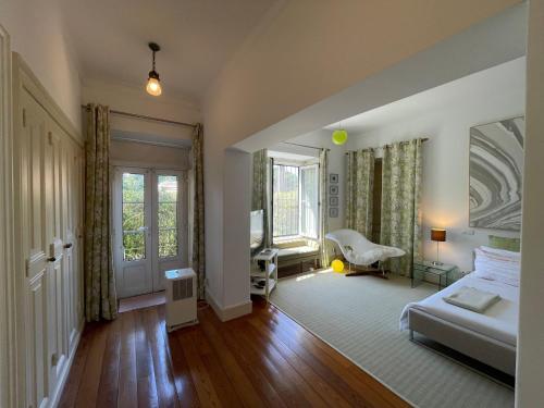 a bedroom with a bed and a chair in it at Sintra Chalet in Sintra